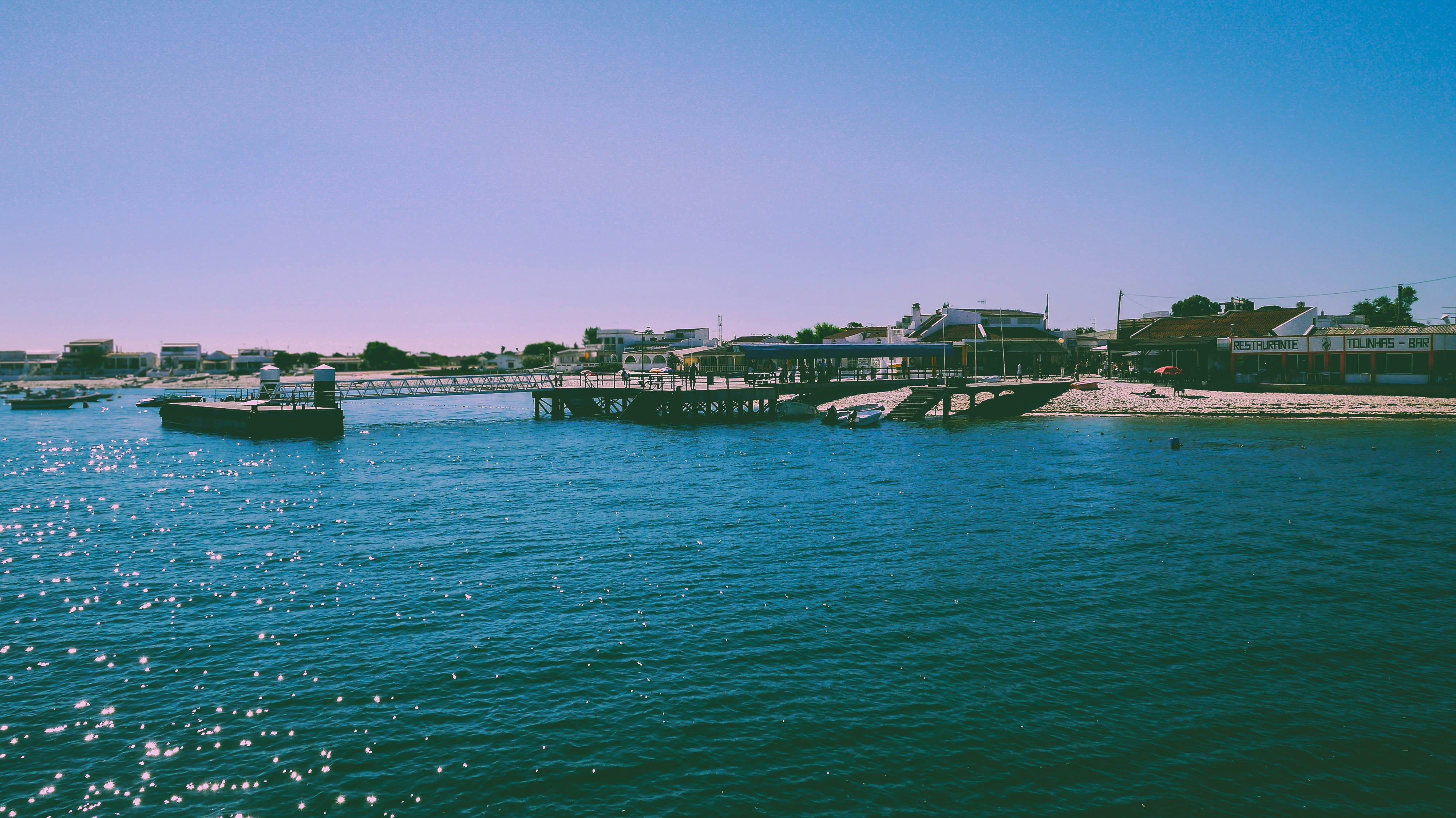 body of water near buildings at daytime